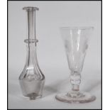 A 18th / 19th Century Georgian cut glass toddy lifter together with a Georgian etched wine glass