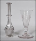 A 18th / 19th Century Georgian cut glass toddy lifter together with a Georgian etched wine glass