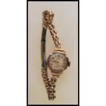 A vintage hallmarked 9ct gold ladies cocktail wrist watch by Avia, having an round white/ silvered