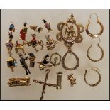 A small collection of yellow metal charms to include a policemen, post box, John Bull having a small