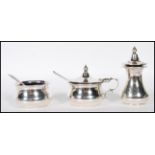 A silver hallmarked 3 piece condiment set to include lidded pot, open pot and pepperette. Blue glass