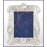 A silver hallmarked Art Nouveau style photo frame having repousse decoration of kingfishers and