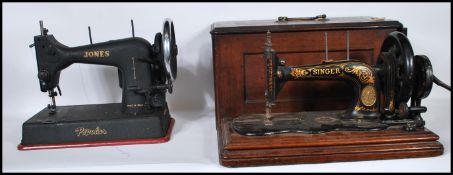 A vintage cased early 20th century Singer sewing machine complete in tha carry box together with