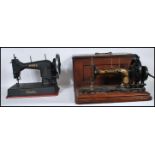 A vintage cased early 20th century Singer sewing machine complete in tha carry box together with