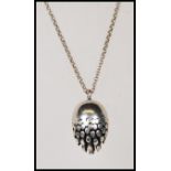 A hallmarked silver pendant necklace having an egg shaped pendant with concentric circle design.