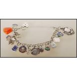 A vintage silver hallmarked charm bracelet having a heart lock with 17 charms to include a stalk,