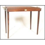 An early 20th Century oak metamorphic butlers tray / table having brass handles to each side with
