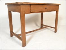 A 19th century French fruitwood  dining table. Raised on squared legs united by stretcher having a