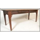A 19th century French fruit wood refectory pine, elm and oak dining table. Of rectangular form