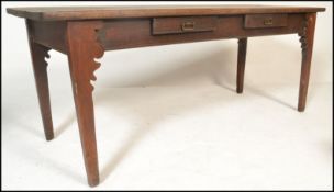 A 19th century French fruit wood refectory pine, elm and oak dining table. Of rectangular form