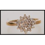 A hallmarked 9ct gold and diamond cluster ring. Hallmarked Sheffield 1995. Estimated diamond