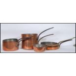 A collection of 19th and 20th Century graduating copper saucepans and skillet pans, stamped WES to