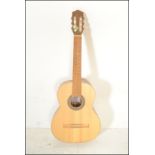 Hokada- An acoustic six string guitar having solid spruce top laminated back & sides to the shaped