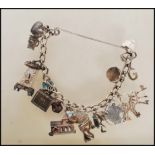 A vintage silver hallmarked heart lock charm bracelet having 16 silver and white metal charms to