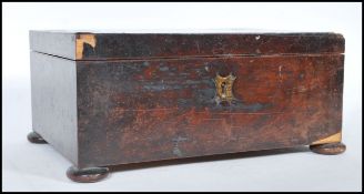A early 19th Century Georgian flame mahogany work box of square form raised on flat bun feet, the