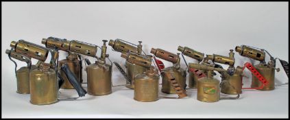 A collection of vintage 20th Century brass and copper blow torches to include many makes such as