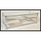 A retro 20th Century circa 1980's glass topped rectangular coffee table raised on chrome supports