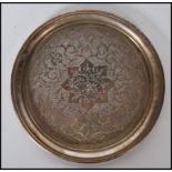A stamped 84 Persian silver coaster having engraved geometric patterning with a flared rim to the