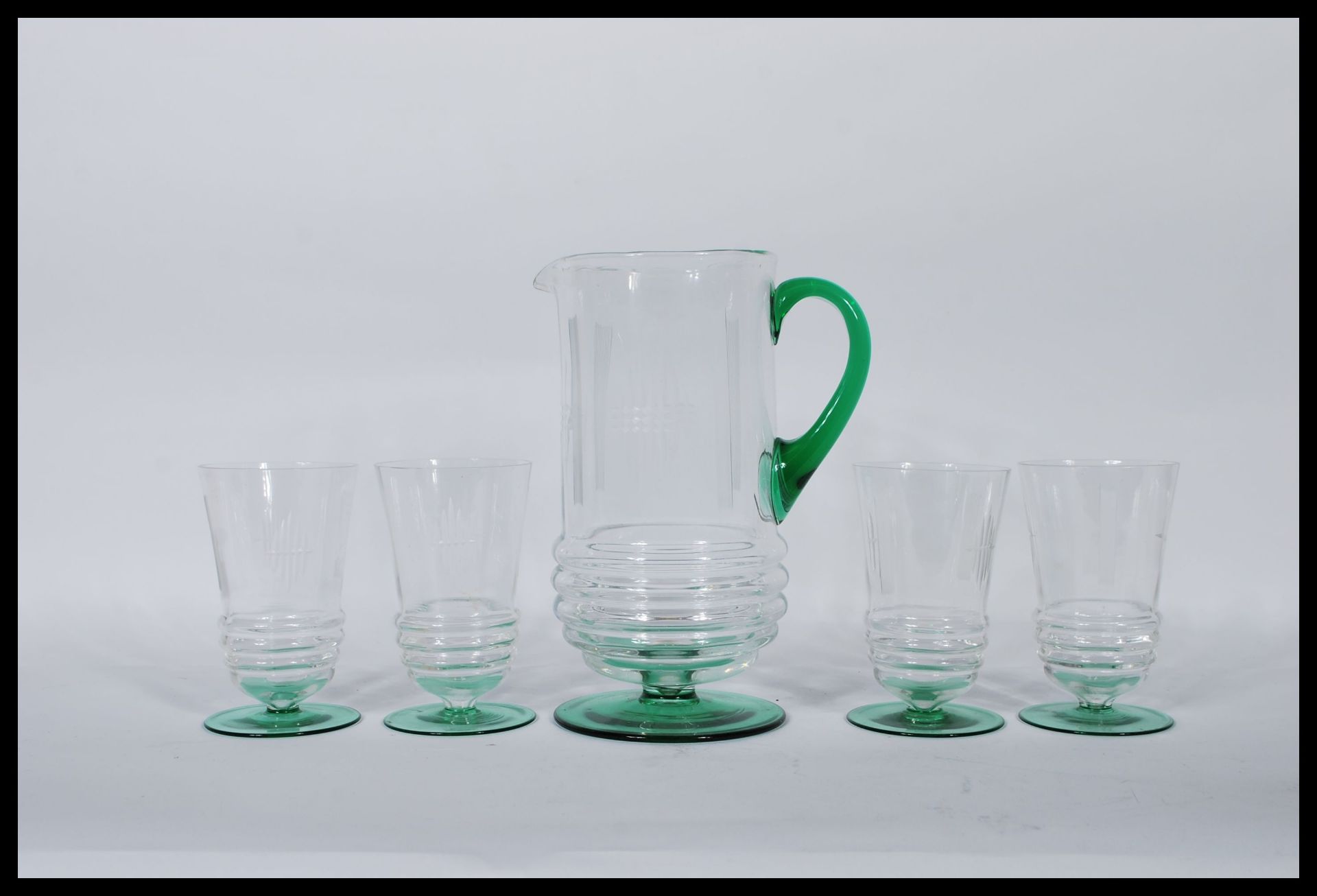 A early 20th Century Art Deco glass lemonade set having etched detailing with green circular
