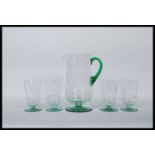 A early 20th Century Art Deco glass lemonade set having etched detailing with green circular