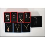 A collection of eight silver ( stamped 925 ) pendant dress necklaces, set with coloured paste