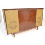 A vintage retro 20th Century walnut cased radiogram by Bush, central walnut panel flanked by