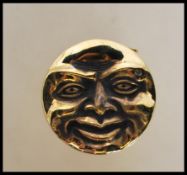 An unusual brass cased vesta in the form of the man in the moon. Polished brass with hinged strike