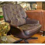 A vintage 1970's brown leather button back and seat leather armchair / swivel chair, having a five