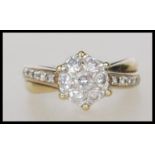 A stamped 9ct gold diamond cluster ring set with seven brilliant cut diamonds to the head, having