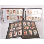 A group of three cigarette card albums including a selection of vintage filmstar cards such as