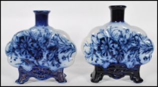 A pair of 19th century Royal Art Pottery Co, Longton blue and white moon flasks. Each being transfer