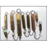 A collection of early 20th Century Salter spring fishing scales of varying sizes.