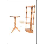An Ercol circular  topped beech and elm wine table raised on turned supports above tripod base