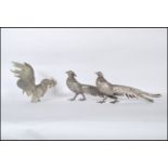A group of 20th Century silver white metal birds to include a male and female pheasant, along with a