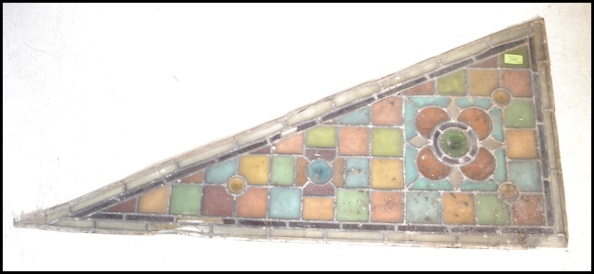 An early 19th Century leaded stained glass Arts and Crafts architectural panel of triangular /