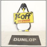 A vintage 20th century Shell advertising board in the form of a penguin with notation to centre. The