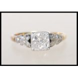 An Art Deco 18ct gold, platinum and diamond ring having a square head with  illusion set round cut