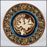 An Austrian 19th century porcelain wall charger having brown glaze with white cameo in relief centre