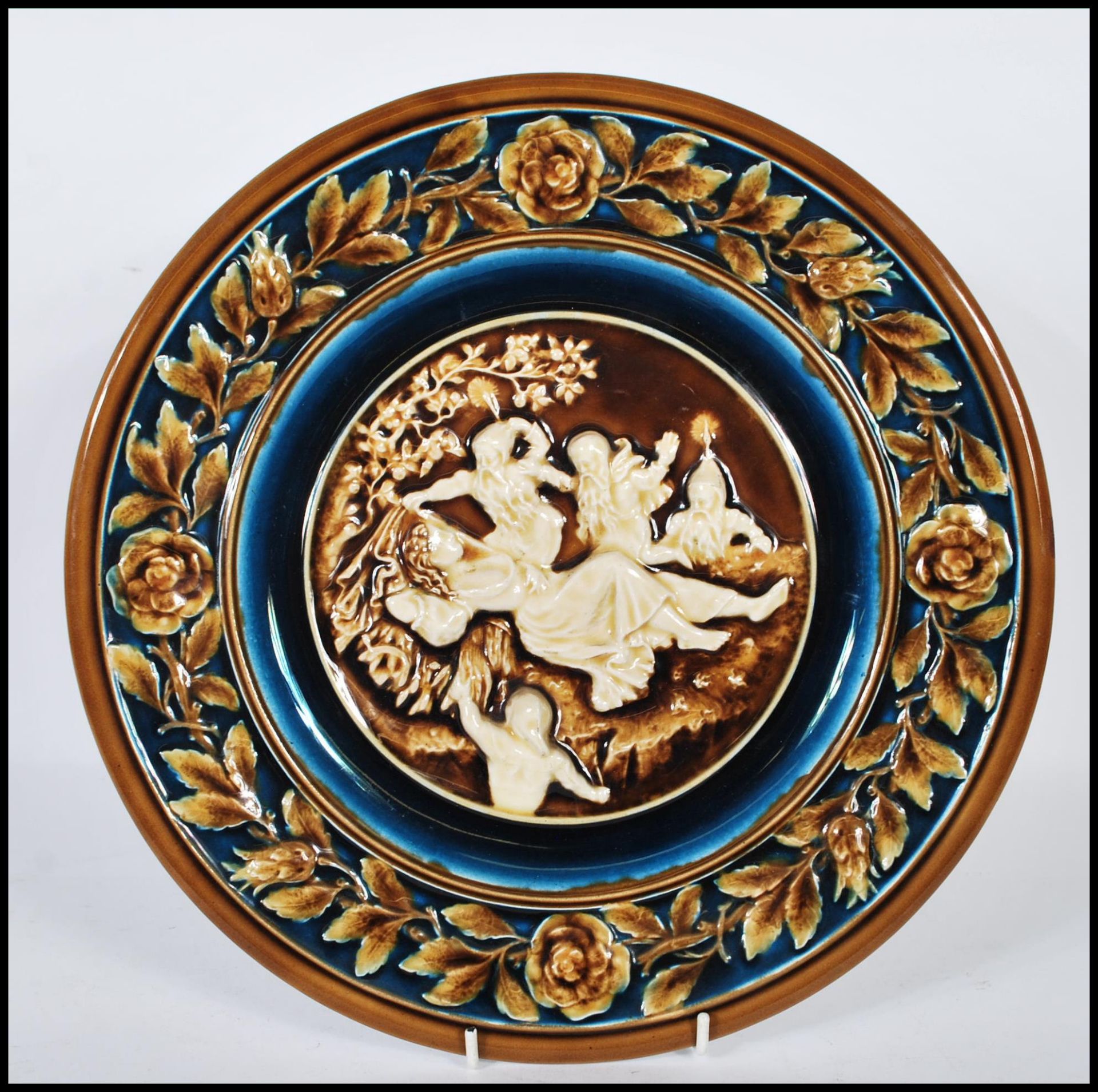 An Austrian 19th century porcelain wall charger having brown glaze with white cameo in relief centre