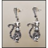 A pair of silver marcasite and opal earrings in the form of cats having mother of pearl cabochon