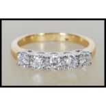 An 18ct yellow gold five stone diamond ring. The diamonds being round brilliant cut totalling approx