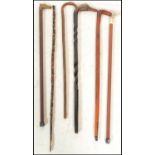 A collection of 20th Century walking canes and sticks to include bamboo, brass horse, handle, duck