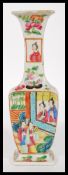 A 19th century Chinese miniature famille rose vase of baluster form being handpainted with scenes of