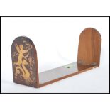 A Sorrento marquetry book slide / stand having two curved folding leaves with inlaid cherub and