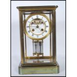 An early 20th Century Mappin &  Webb gilt brass bevelled glass panelled mantel clock having a