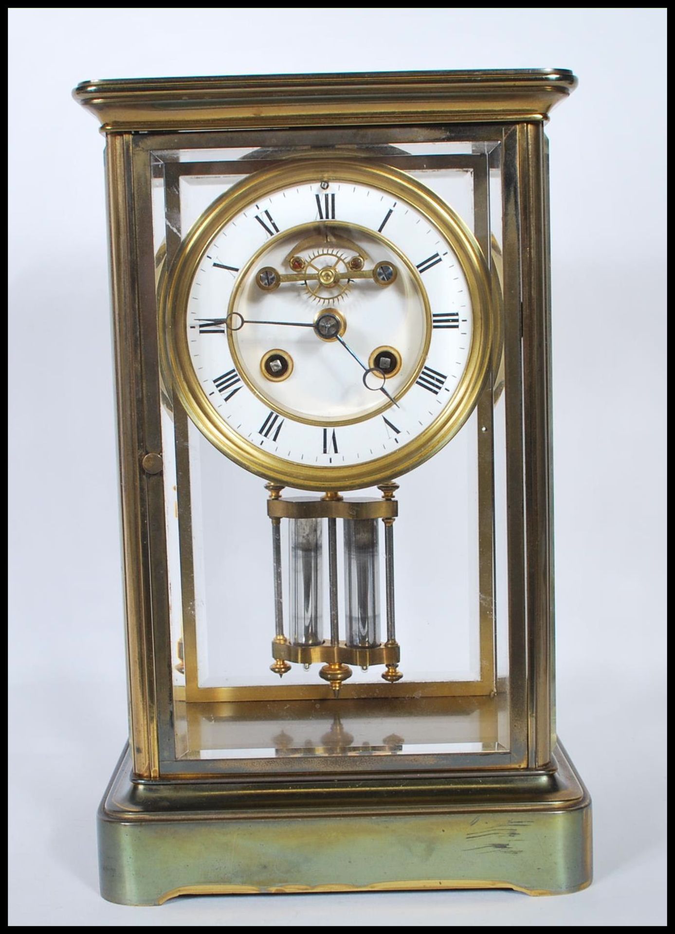 An early 20th Century Mappin &  Webb gilt brass bevelled glass panelled mantel clock having a