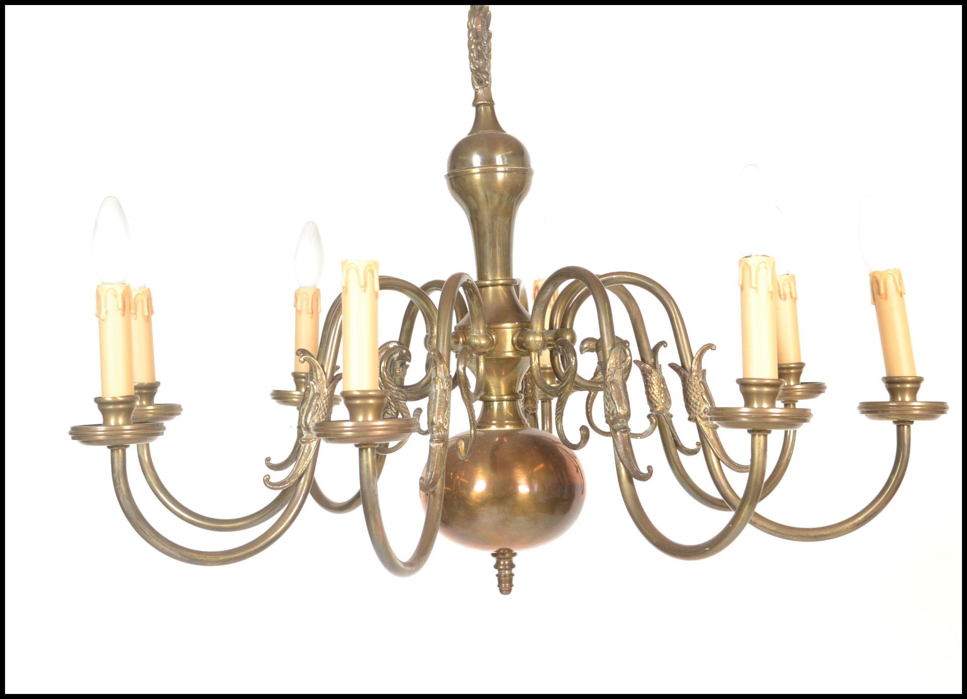 A 19th century style Dutch brass eight branch chandelier, with eight scrolling branches emanating