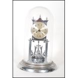 A 20th century Continental chrome anniversary clock, the silvered dial with Arabic numerals denoting