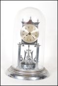 A 20th century Continental chrome anniversary clock, the silvered dial with Arabic numerals denoting