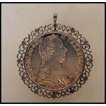 A silver Maria Theresa Silver Thaler coin, bearing the date 1780, mounted within a silver hallmarked